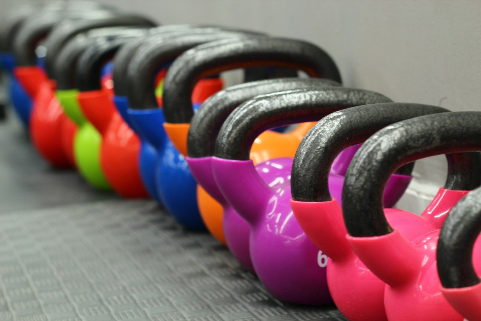 Kettlebells lined up in a gym