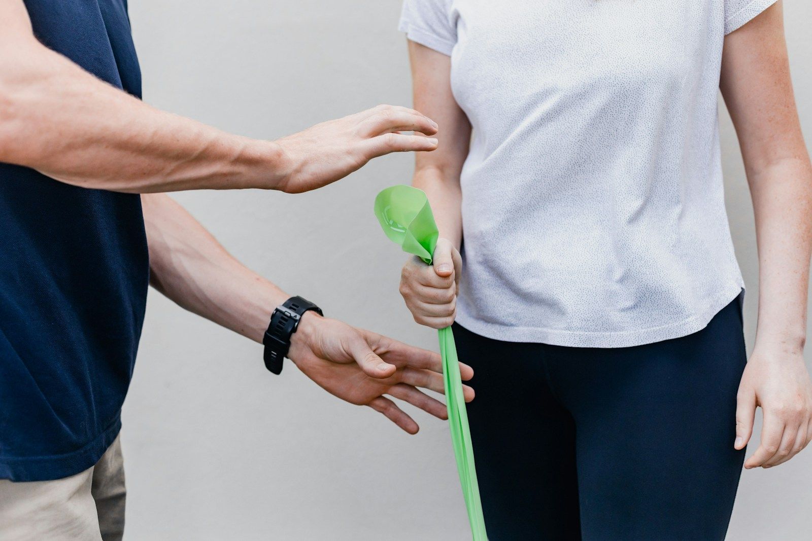 A physiotherapist working with a patient using a resistance band